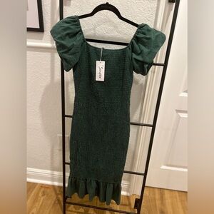 Stretchy mid-length green dress.